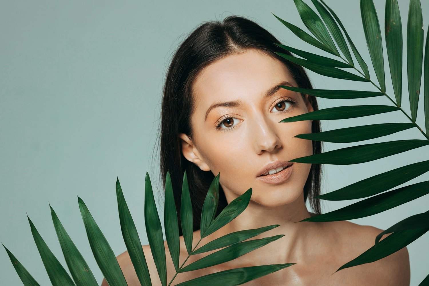 brunette-girl-posing-with-exotic-leaves